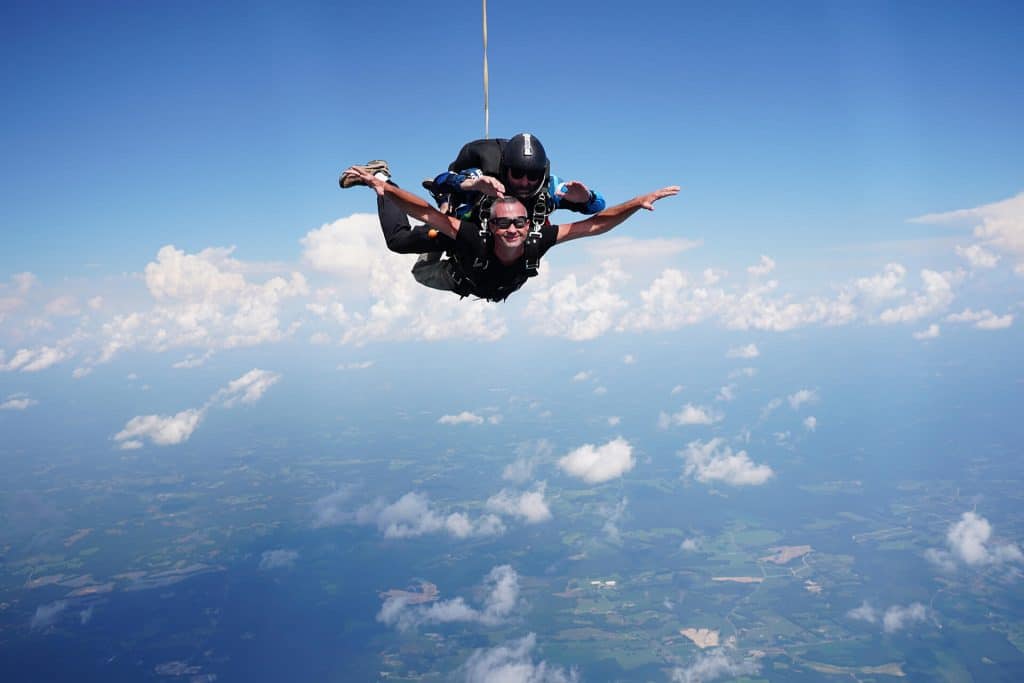 person smiling while tandem skydiving in Franklinton, NC
