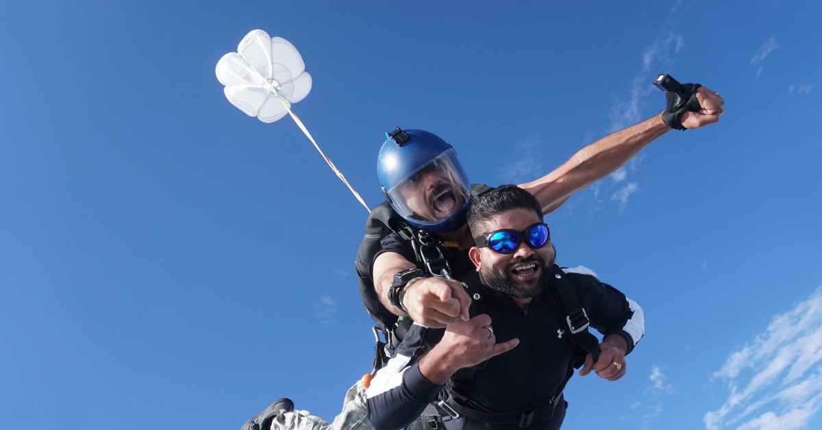 Tandem skydivers in freefall with drogue parachute deployed